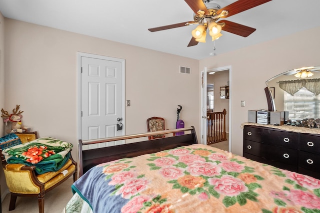 bedroom featuring ceiling fan and carpet