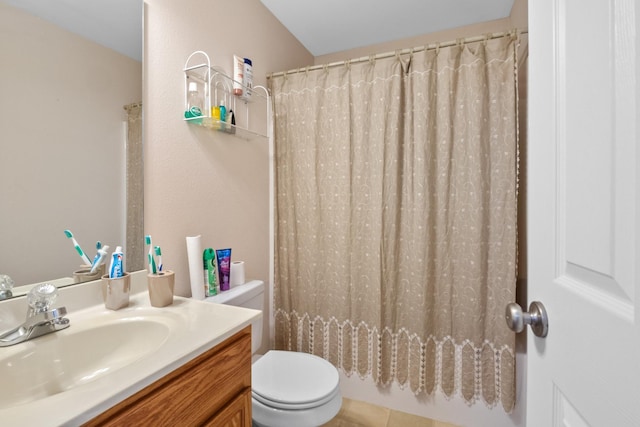 bathroom featuring toilet, vanity, and curtained shower