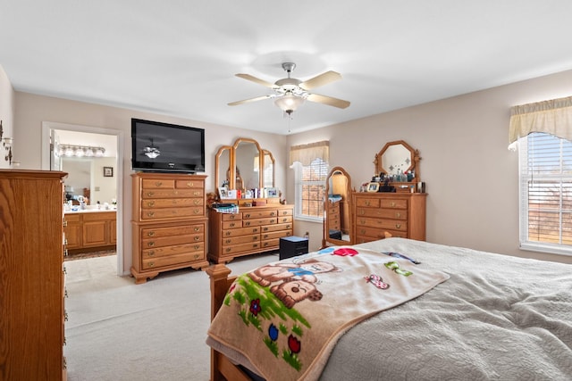 carpeted bedroom with ceiling fan and ensuite bathroom