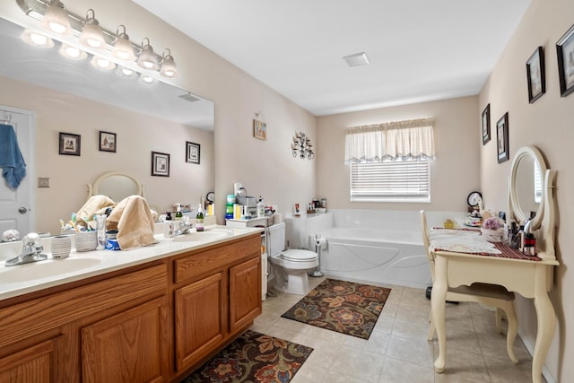 bathroom with toilet, vanity, and a bathtub