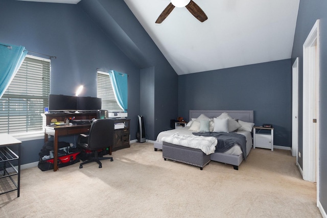 carpeted bedroom with ceiling fan and high vaulted ceiling