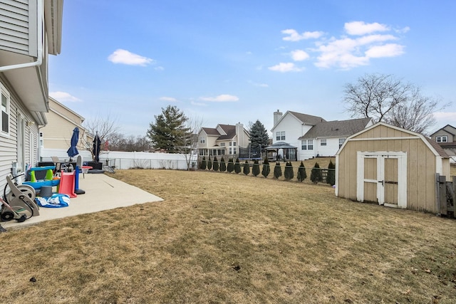 view of yard featuring a shed and a patio