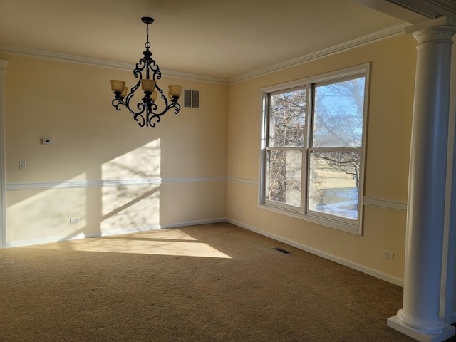 unfurnished dining area featuring ornate columns, ornamental molding, carpet floors, and a notable chandelier