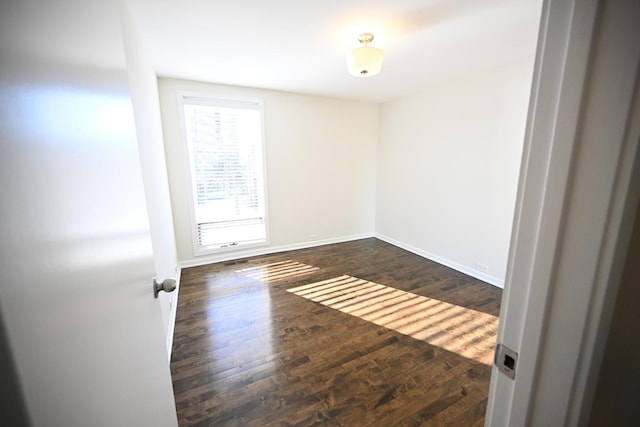 spare room featuring dark hardwood / wood-style floors