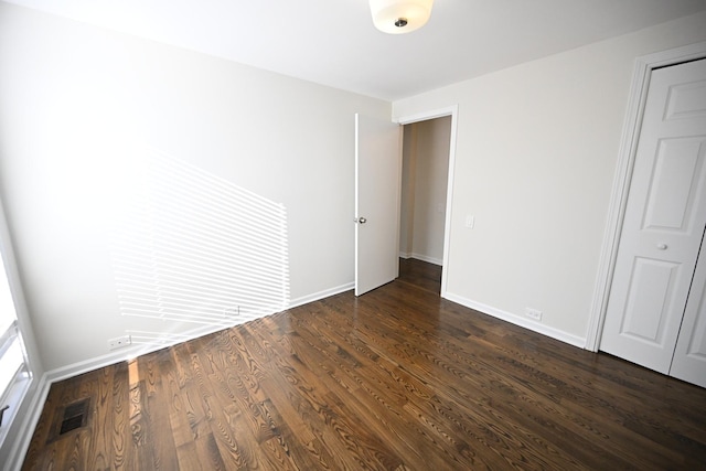 unfurnished room featuring dark hardwood / wood-style floors