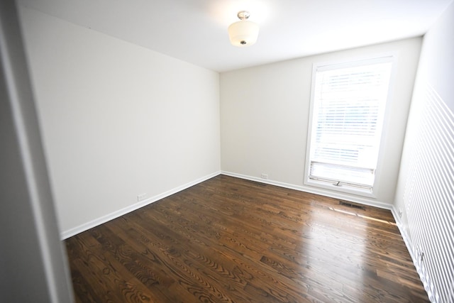 spare room with dark hardwood / wood-style floors