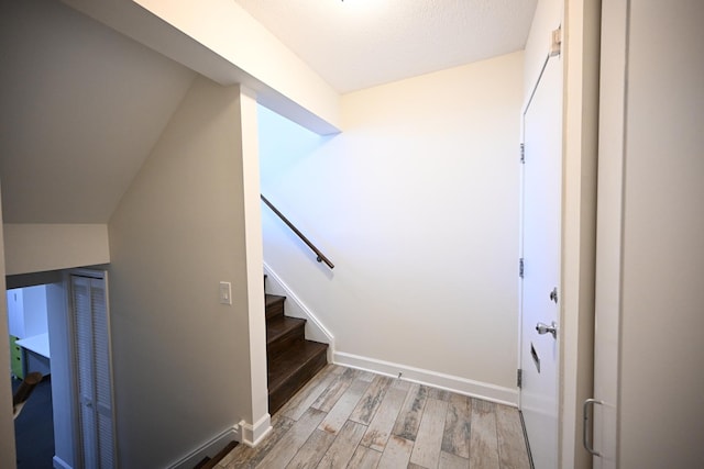 stairway with hardwood / wood-style flooring