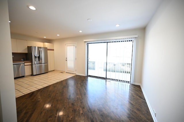 interior space featuring light hardwood / wood-style floors, white cabinetry, and stainless steel appliances