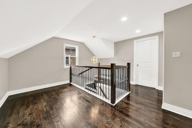 bonus room featuring dark hardwood / wood-style flooring and lofted ceiling