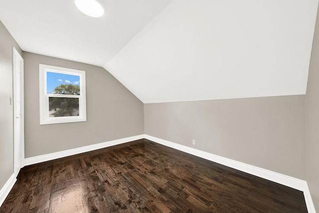 bonus room with vaulted ceiling and dark hardwood / wood-style floors