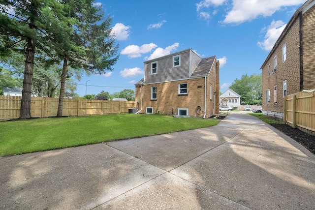 rear view of property featuring a lawn