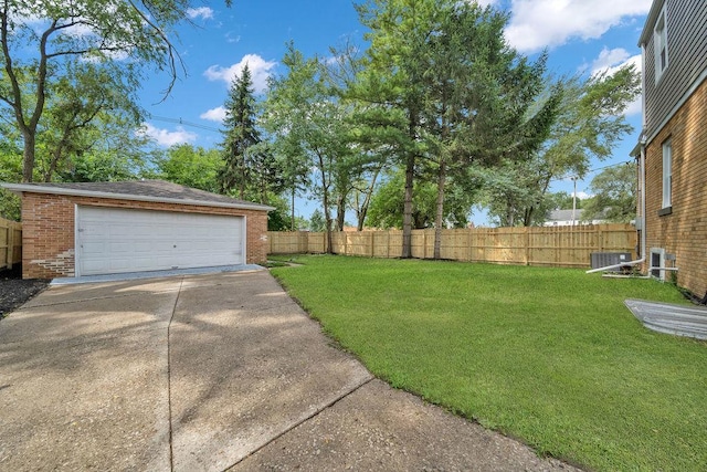 view of yard featuring central air condition unit, an outdoor structure, and a garage