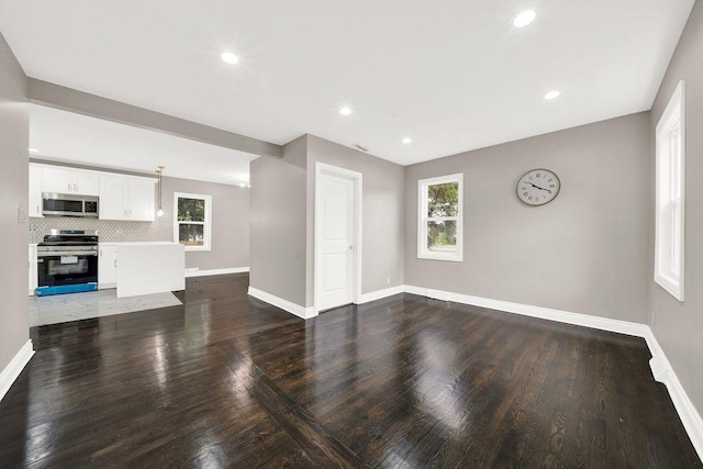 unfurnished living room featuring dark hardwood / wood-style flooring