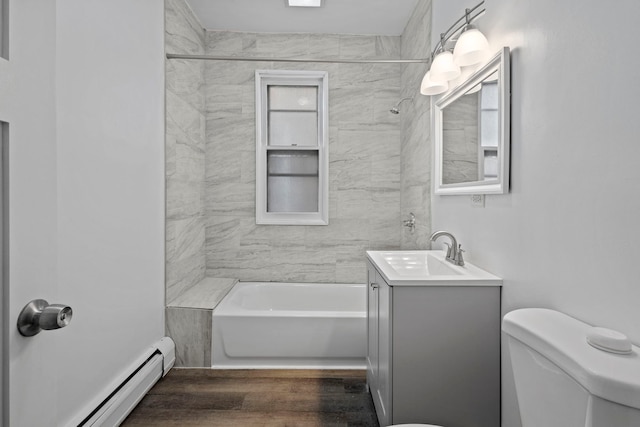 full bathroom with a baseboard radiator, tiled shower / bath, vanity, toilet, and hardwood / wood-style flooring