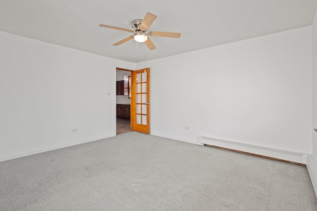 carpeted spare room featuring ceiling fan and baseboard heating