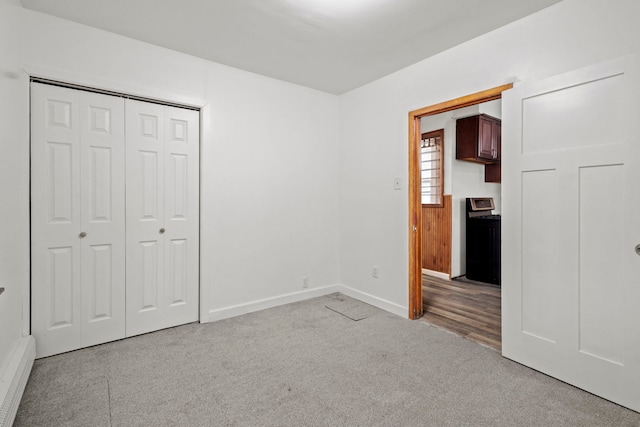 unfurnished bedroom featuring a closet and light colored carpet