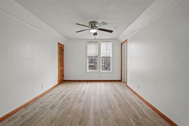 empty room with ceiling fan, light hardwood / wood-style flooring, and lofted ceiling