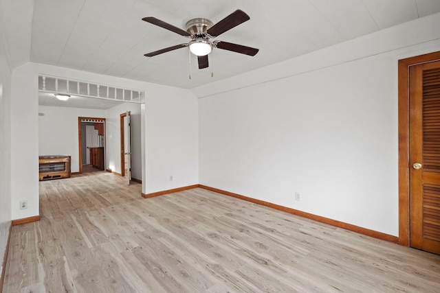 spare room featuring light hardwood / wood-style floors, ceiling fan, and vaulted ceiling