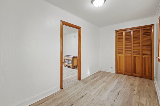 unfurnished bedroom with a closet and light hardwood / wood-style flooring