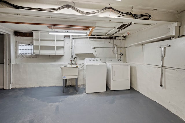 basement with sink and washing machine and clothes dryer