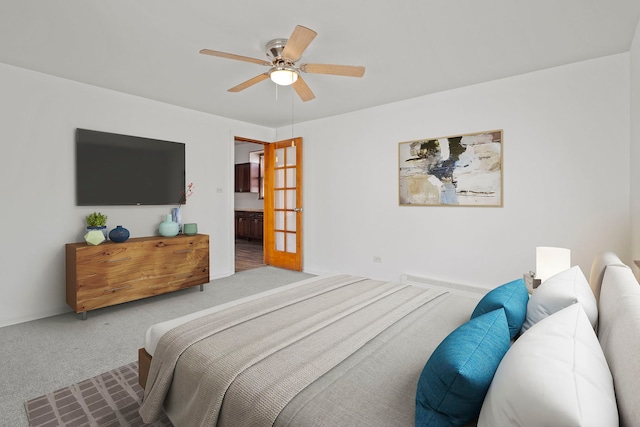 carpeted bedroom featuring ceiling fan and connected bathroom