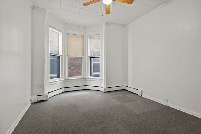 unfurnished room with ceiling fan, a healthy amount of sunlight, dark colored carpet, and crown molding