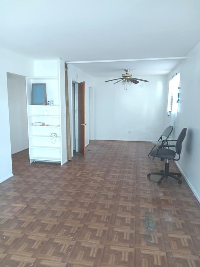 unfurnished room with dark parquet flooring and ceiling fan