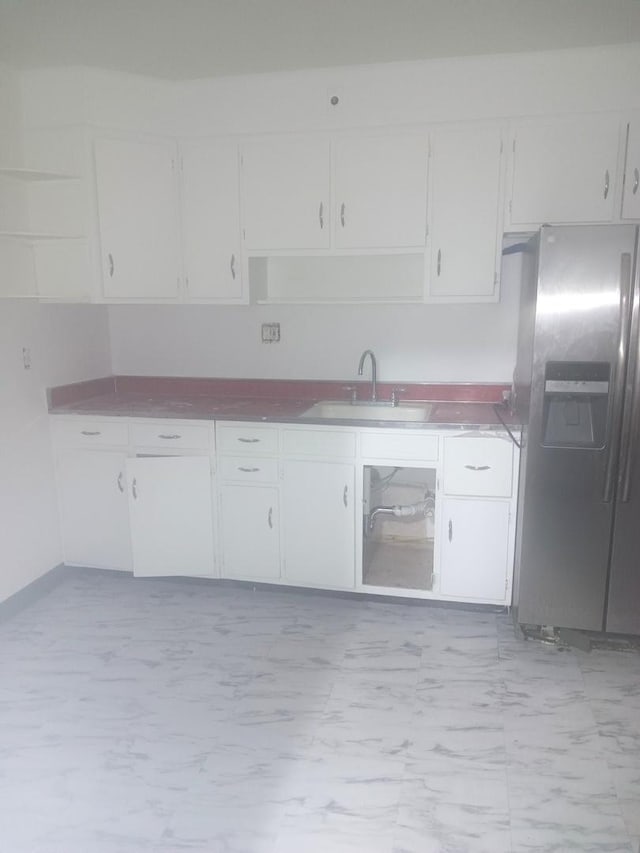 kitchen featuring sink, white cabinets, and stainless steel fridge with ice dispenser