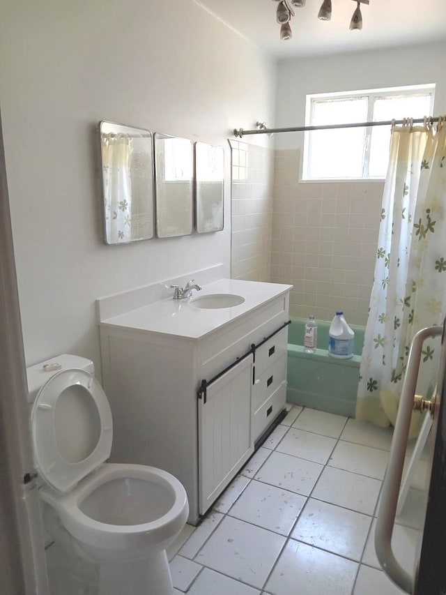 full bathroom featuring shower / tub combo with curtain, vanity, tile patterned flooring, and toilet