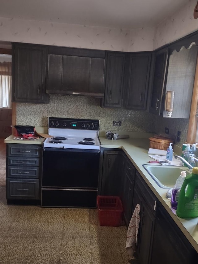 kitchen with light tile patterned floors, sink, dark brown cabinets, and electric range oven