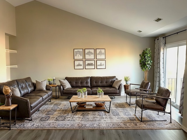 living room featuring hardwood / wood-style floors and vaulted ceiling