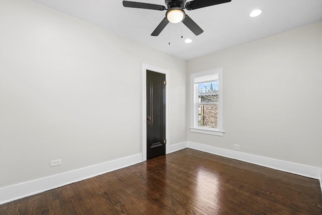 empty room featuring ceiling fan and dark wood-type flooring