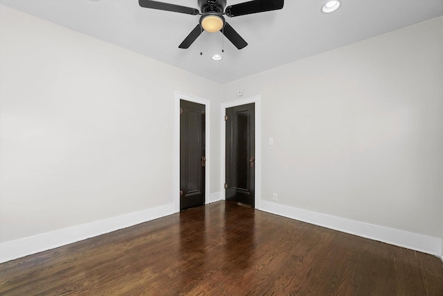 spare room featuring ceiling fan and dark hardwood / wood-style flooring