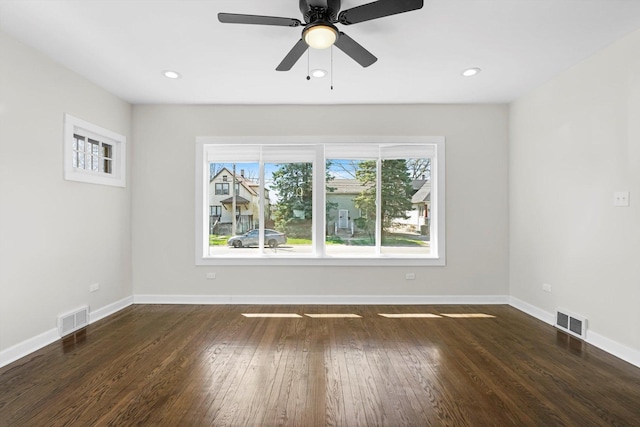 unfurnished room with ceiling fan, dark hardwood / wood-style flooring, and plenty of natural light