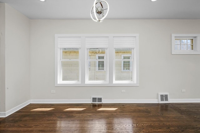 empty room featuring dark hardwood / wood-style flooring