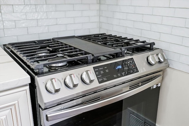 room details featuring decorative backsplash and gas stove