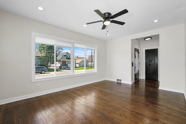 spare room featuring ceiling fan and dark hardwood / wood-style floors