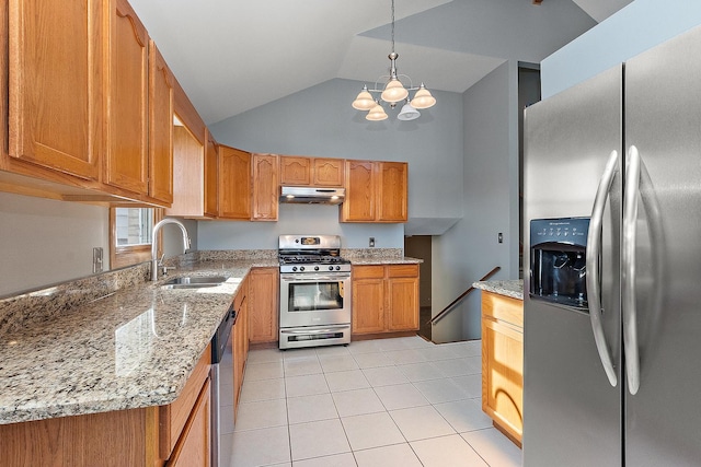 kitchen with decorative light fixtures, sink, light stone counters, and appliances with stainless steel finishes