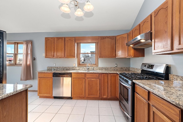 kitchen with light stone countertops, sink, appliances with stainless steel finishes, and light tile patterned flooring