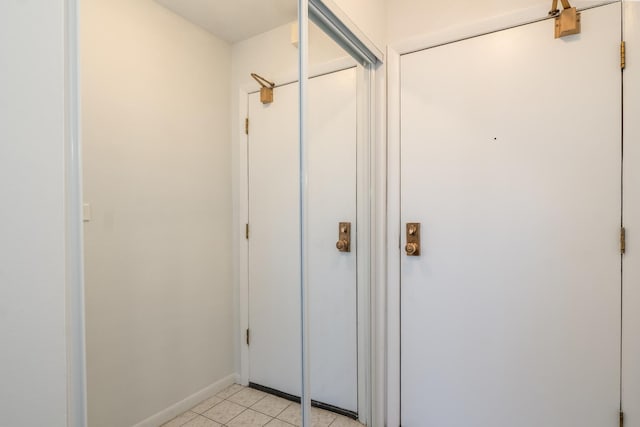 hall with light tile patterned floors