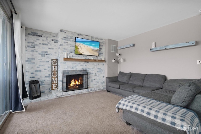 living room featuring light carpet and a large fireplace