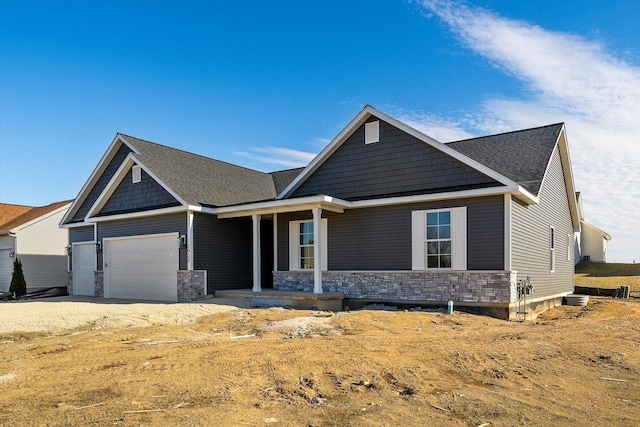 craftsman-style house with a garage and covered porch