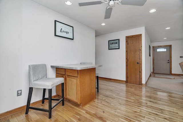 office area with light wood-type flooring and ceiling fan