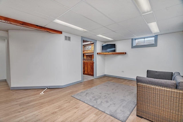 unfurnished room with light hardwood / wood-style floors and a paneled ceiling