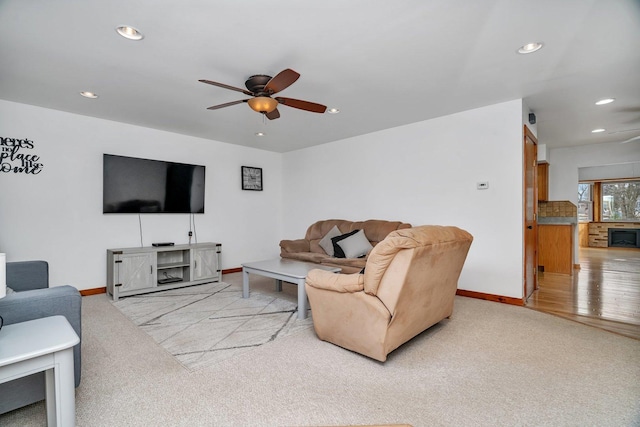 carpeted living room with ceiling fan