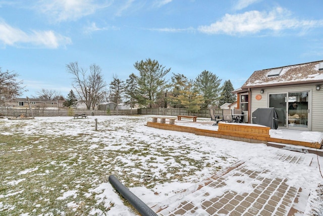 yard layered in snow with a wooden deck