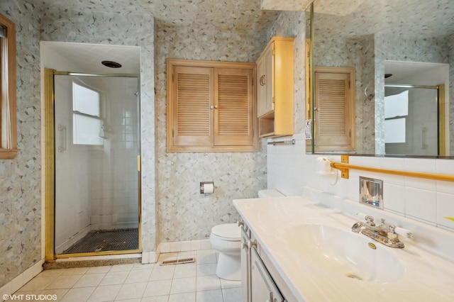 bathroom with an enclosed shower, vanity, tile patterned floors, and toilet