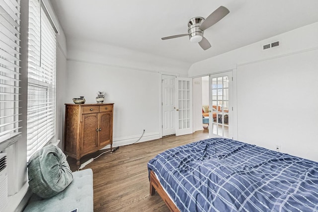 bedroom with ceiling fan, french doors, and wood-type flooring