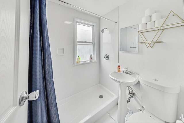 bathroom featuring toilet, tile patterned flooring, and walk in shower