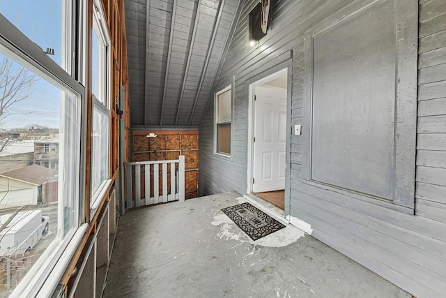 unfurnished sunroom featuring lofted ceiling